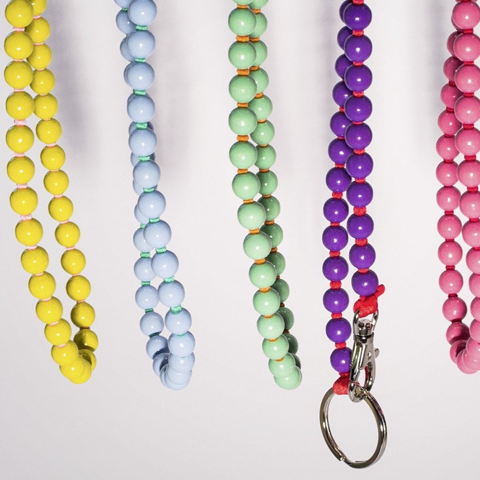 multiple colorways of the ina seifart keychain. the colours are yellow, blue, green, purple and pink. The keychains are produced in Berlin and the materials are sourced within Germany cruba