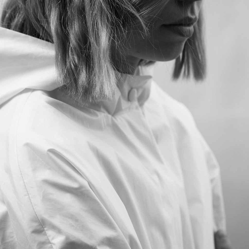 rain coat lined with cotton and water repellent and buttons. The color is off white and produced locally. cruba