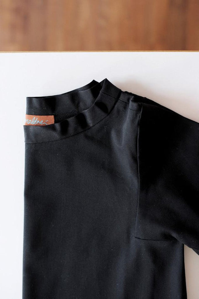 basic black maternity top with back-slanting side seam and back support. maternity working clothing, everyday wear, chic clothing, basic maternity tops. cruba