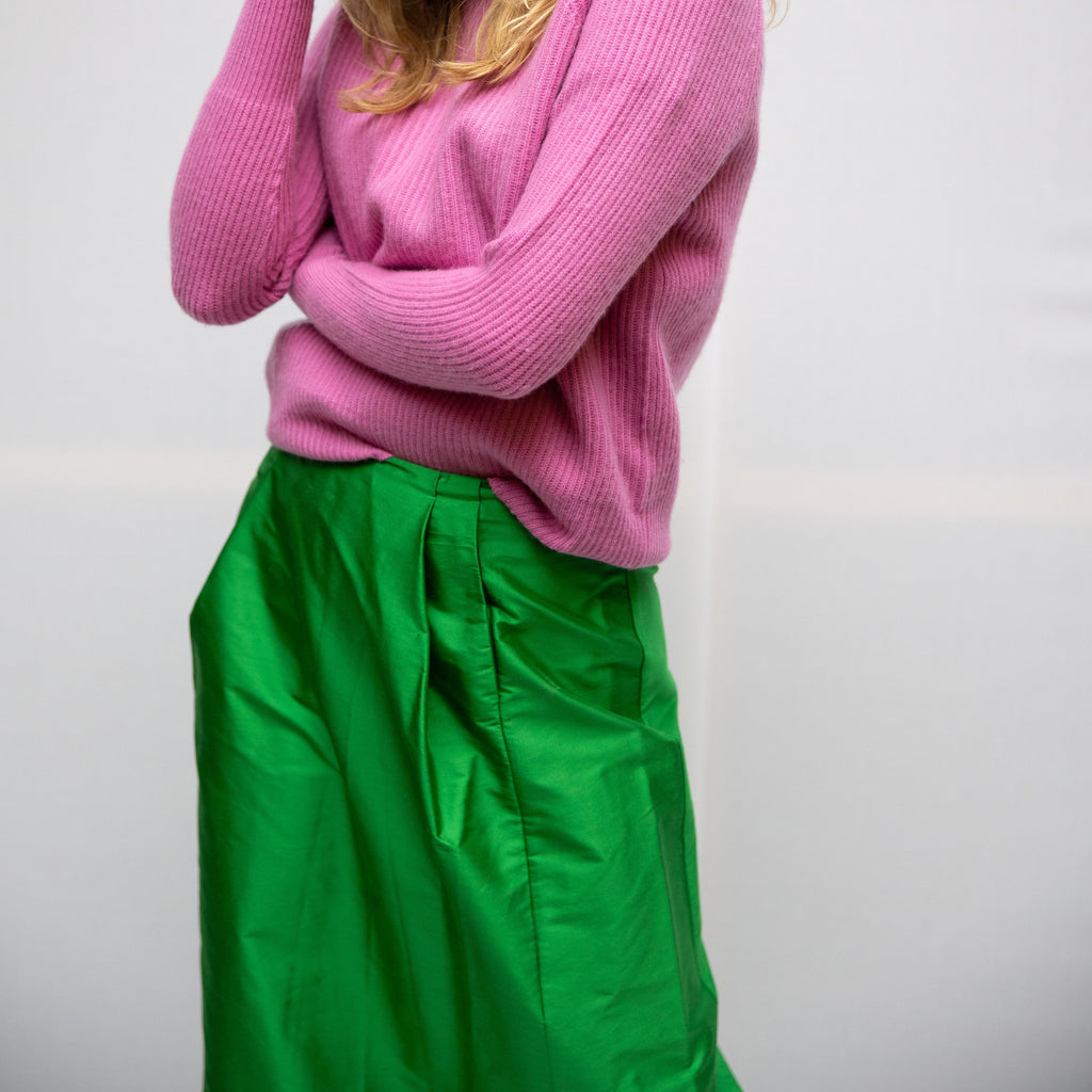 Our model is wearing our bubble gum pink merino wool and cashmere sweater with the silk, apple green bonding skirt. The colour blocking is trendy and is meant for everyday wear. cruba
